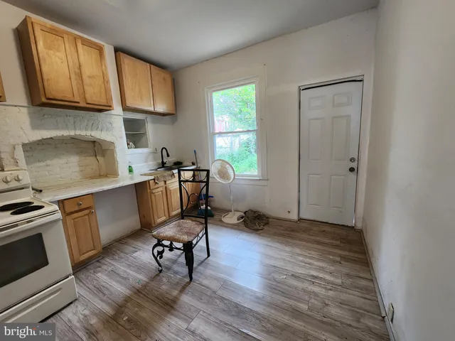 a kitchen with sink cabinets and wooden floor