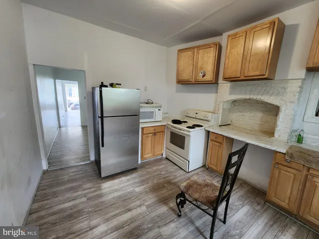 a kitchen with a refrigerator a stove top oven a sink and dishwasher