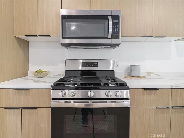 a stove top oven sitting inside of a kitchen