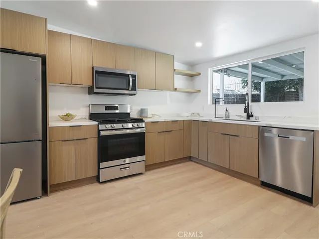 a kitchen with a sink stove and refrigerator