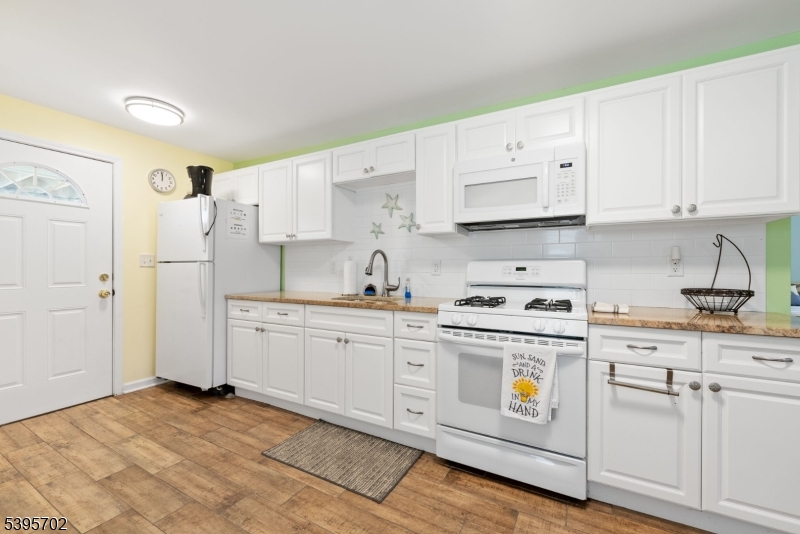 15 7th Avenue Seaside Heights, NJ 08751 - Photo 14 of 27 a kitchen with cabinets appliances a sink and a counter space
