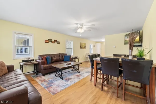 a living room with furniture wooden floor and dining table