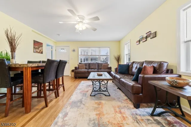 a living room with furniture a dining table and a piano