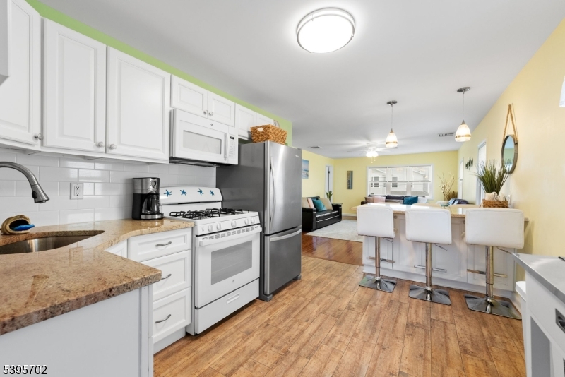 15 7th Avenue Seaside Heights, NJ 08751 - Photo 8 of 27 a kitchen with stainless steel appliances granite countertop a stove a sink dishwasher and a refrigerator