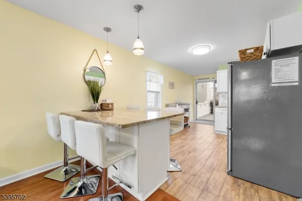a view of a kitchen area with furniture and wooden floor
