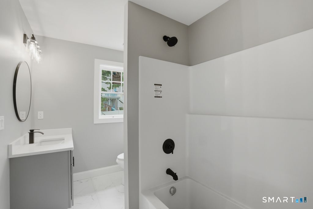 796 Maple Hill Road Naugatuck, CT 06770 - Photo 19 of 35 a bathroom with a sink a toilet and shower