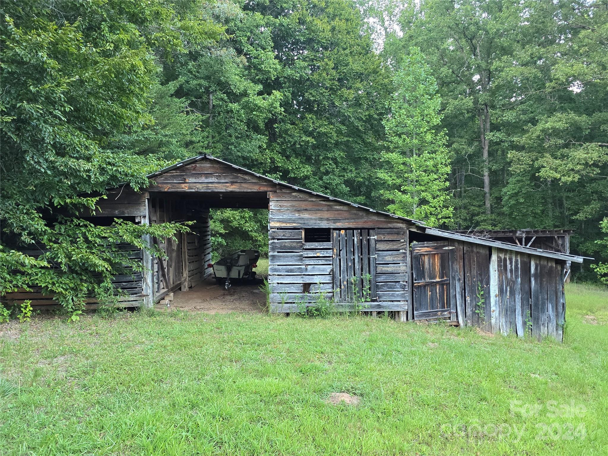 206 Fallen Oaks Lane Rutherfordton, NC 28139 - Photo 13 of 26 a backyard of a house with barbeque oven and outdoor seating