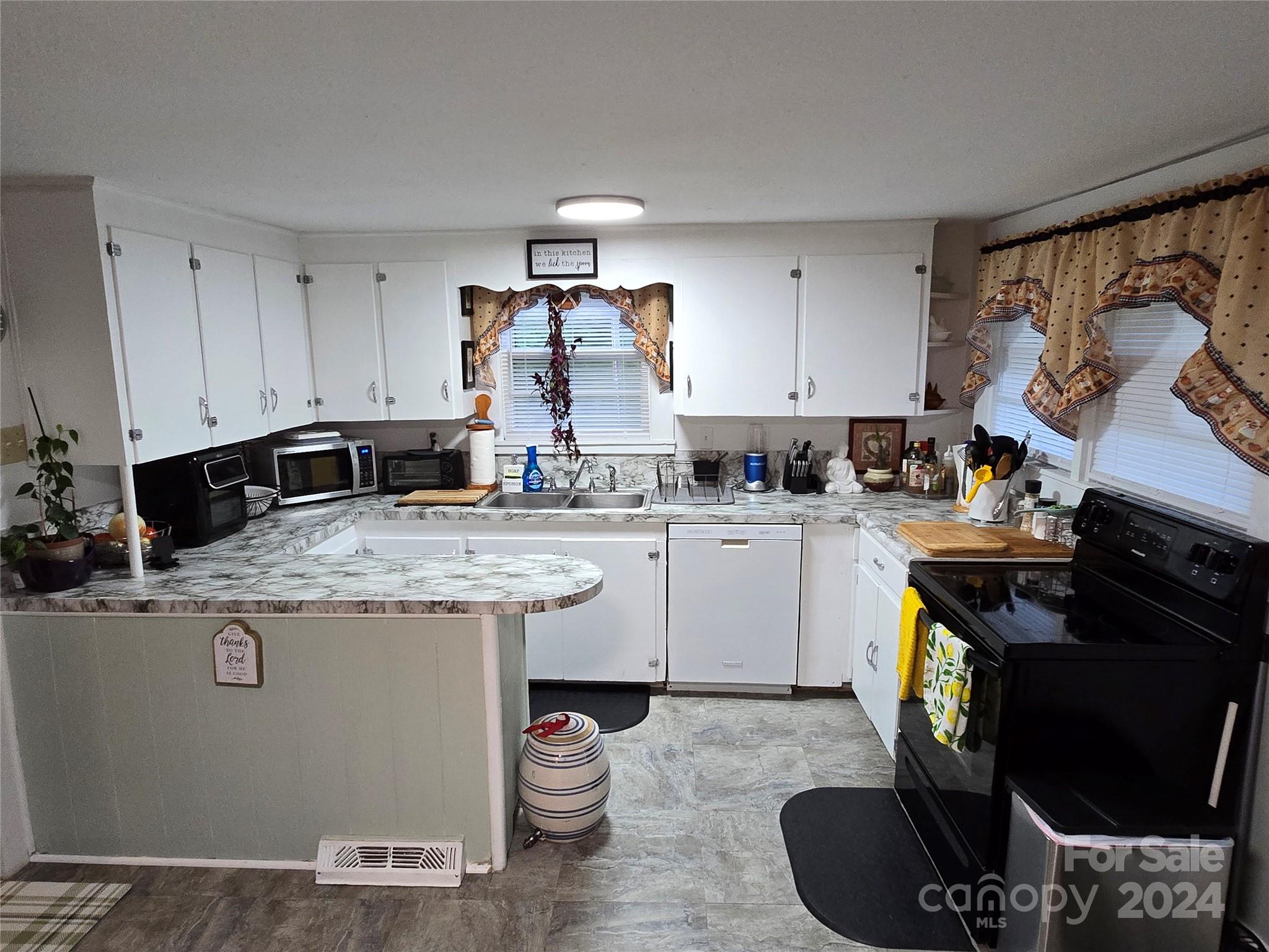 206 Fallen Oaks Lane Rutherfordton, NC 28139 - Photo 21 of 26 a kitchen with a stove top oven sink and cabinets