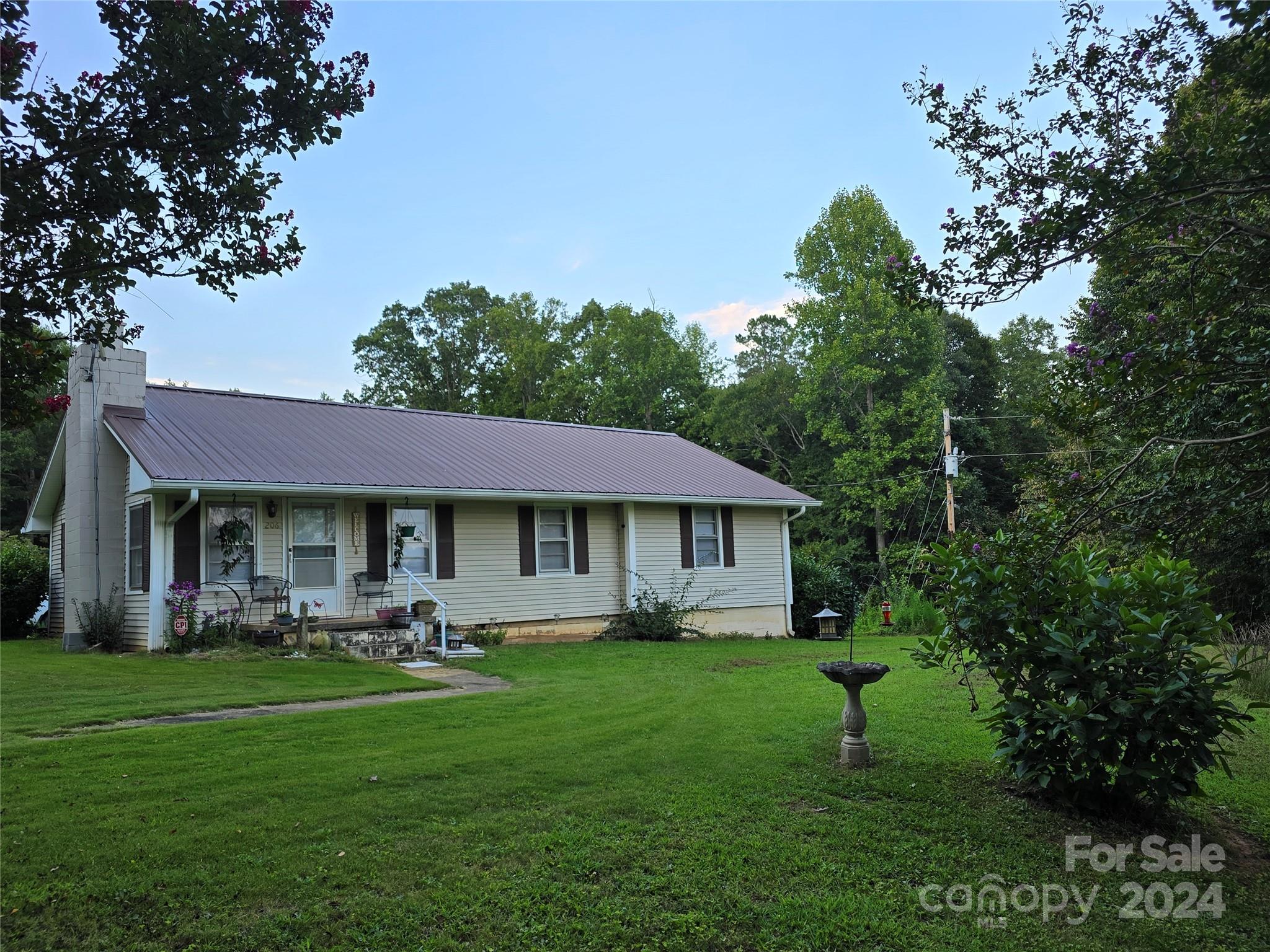 206 Fallen Oaks Lane Rutherfordton, NC 28139 - Photo 6 of 26 a front view of a house with table and chairs
