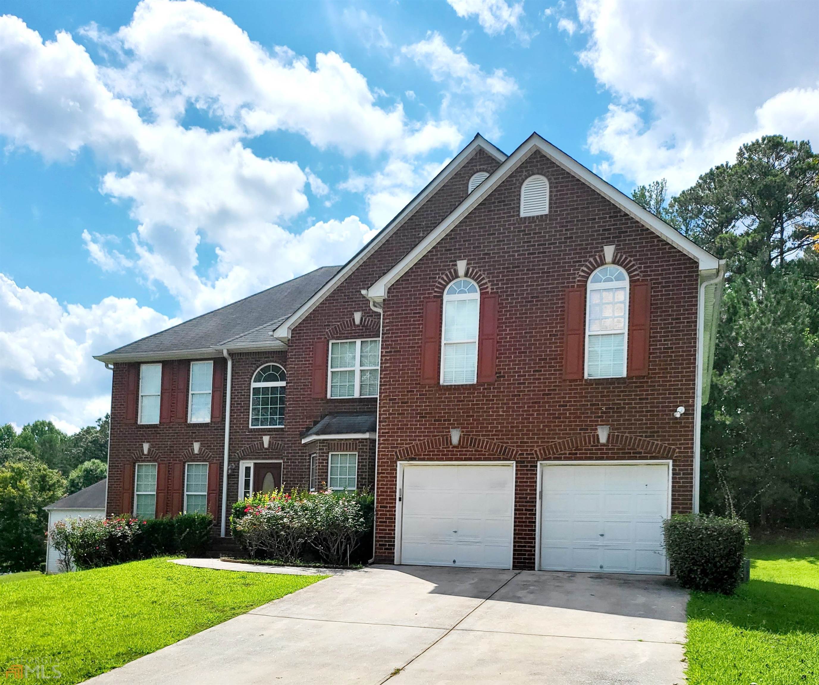 3180 Westheimer Road Stone Mountain, GA 30087 - Photo 1 of 1 a front view of a house with garden