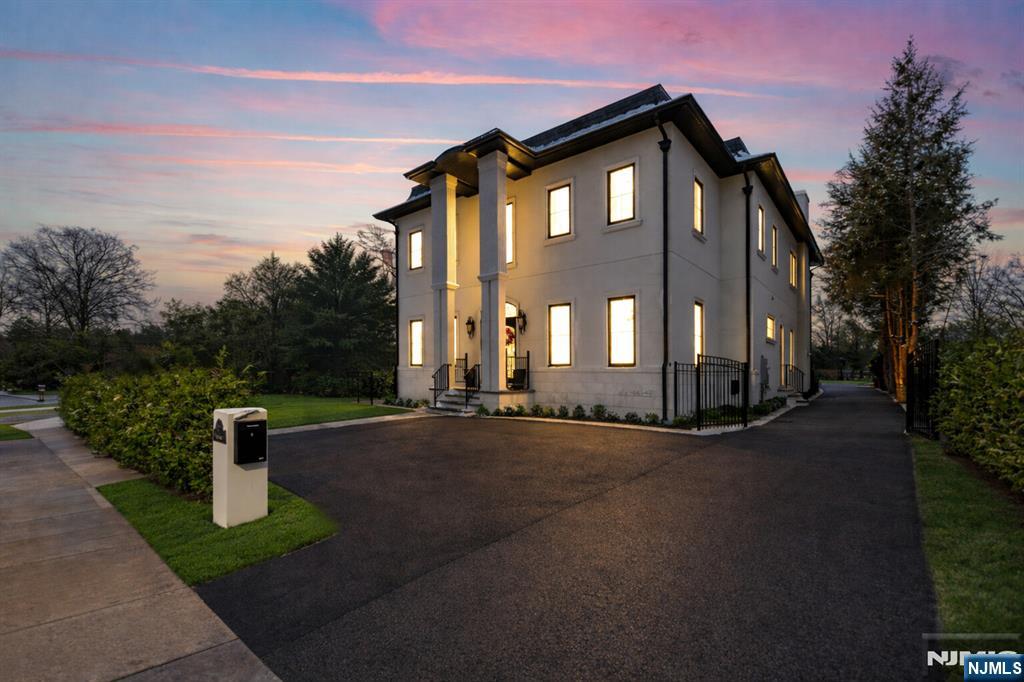 a front view of a house with a garden and yard