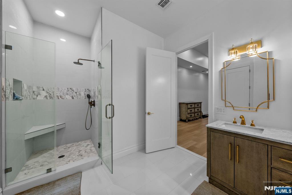 472 High Street Closter, NJ 07624 - Photo 11 of 38 a bathroom with a tub sink and mirror