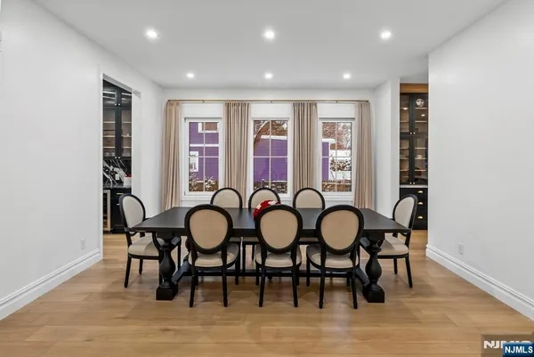 a living room with a black white checkered floor with couches chair and a coffee table
