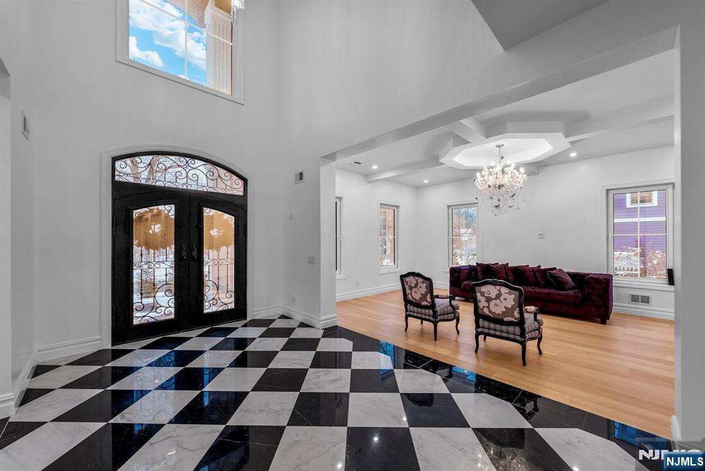 472 High Street Closter, NJ 07624 - Photo 24 of 34 a living room with a black white checkered floor with couches chair and a coffee table
