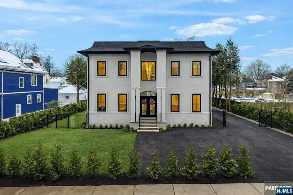 a front view of house with yard and green space