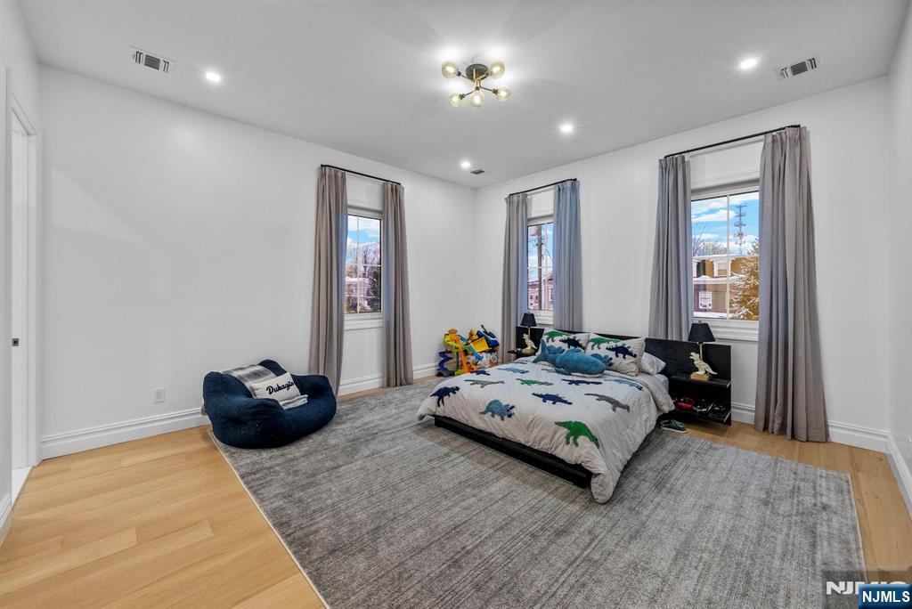 472 High Street Closter, NJ 07624 - Photo 6 of 34 a bedroom with furniture and a chandelier