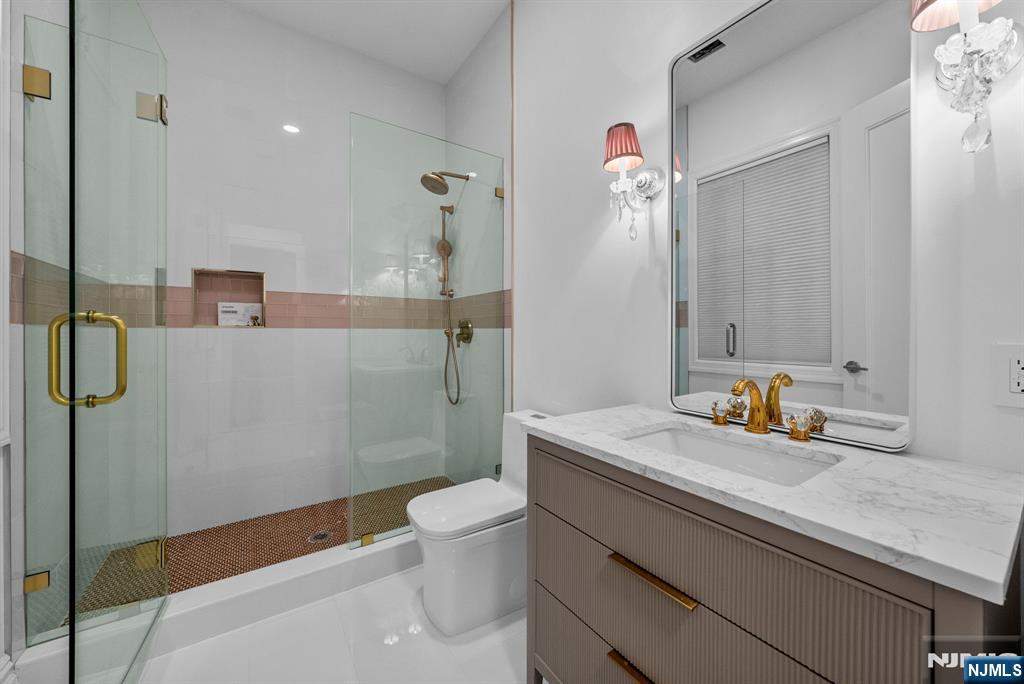 472 High Street Closter, NJ 07624 - Photo 7 of 34 a bathroom with a sink a toilet and shower
