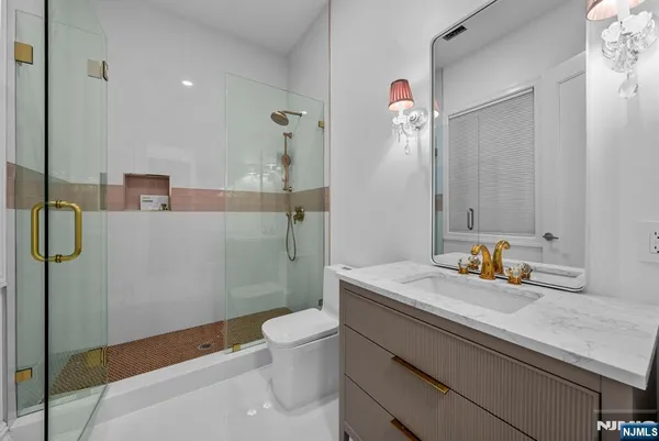 a bathroom with a tub sink and mirror