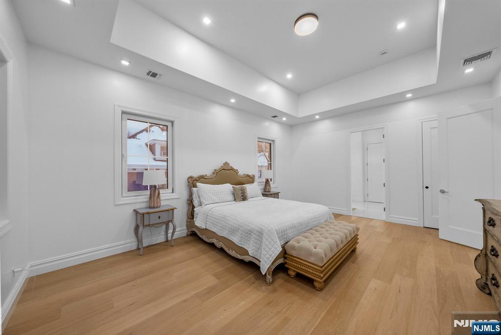 472 High Street Closter, NJ 07624 - Photo 10 of 34 a spacious bedroom with a bed and a table