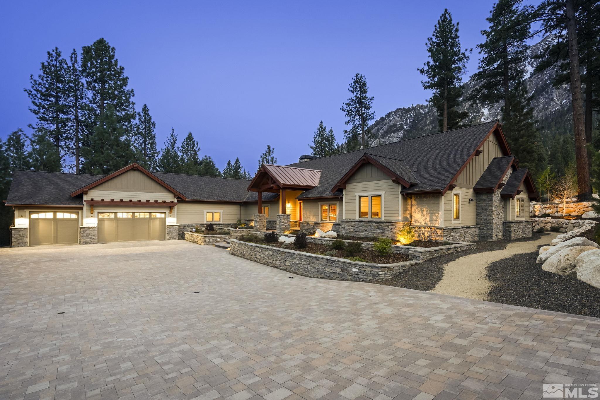 a view of a large house with a yard and large trees