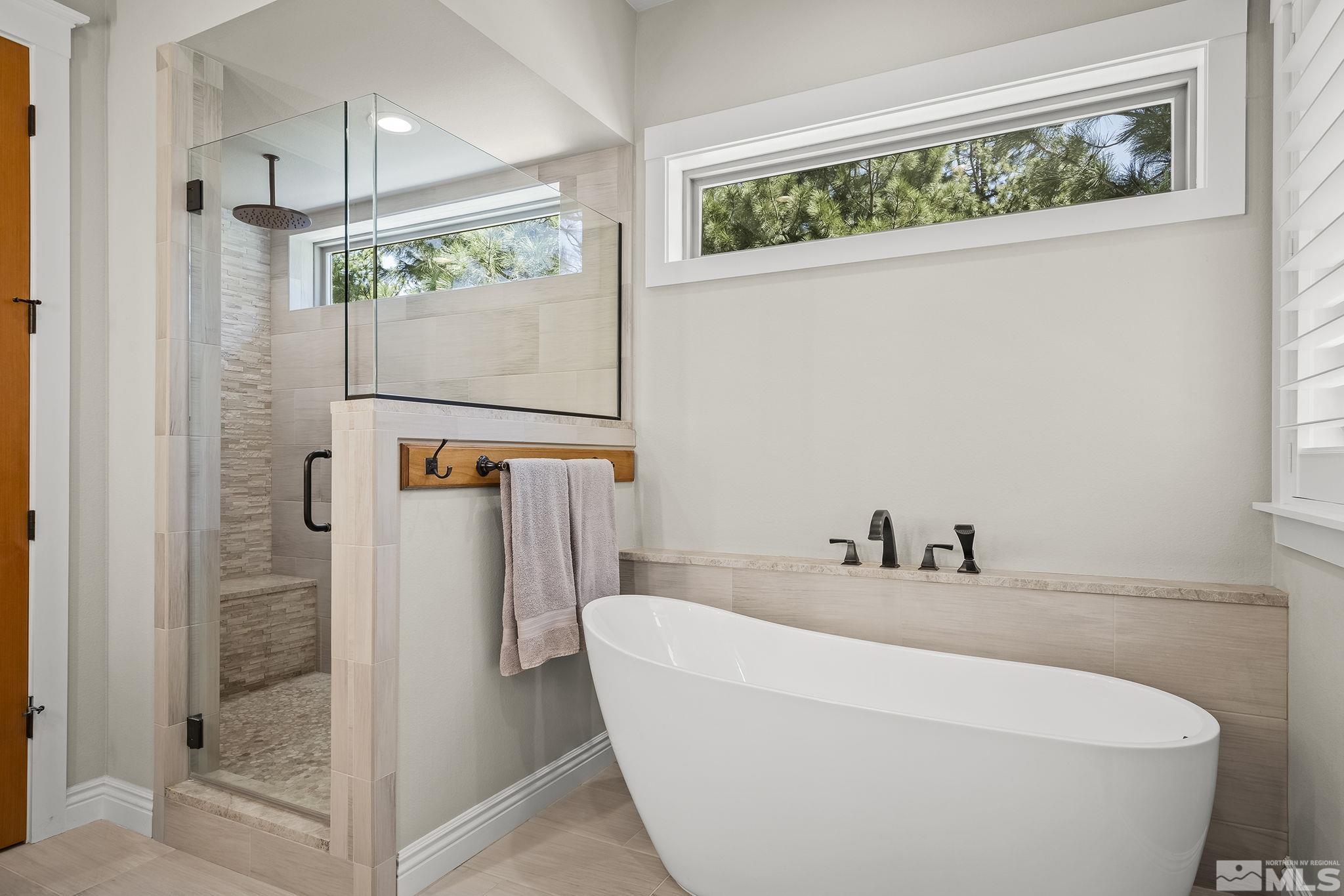 119 Five Creek Road Gardnerville, NV 89460 - Photo 23 of 40 a bathroom with a bathtub and a shower