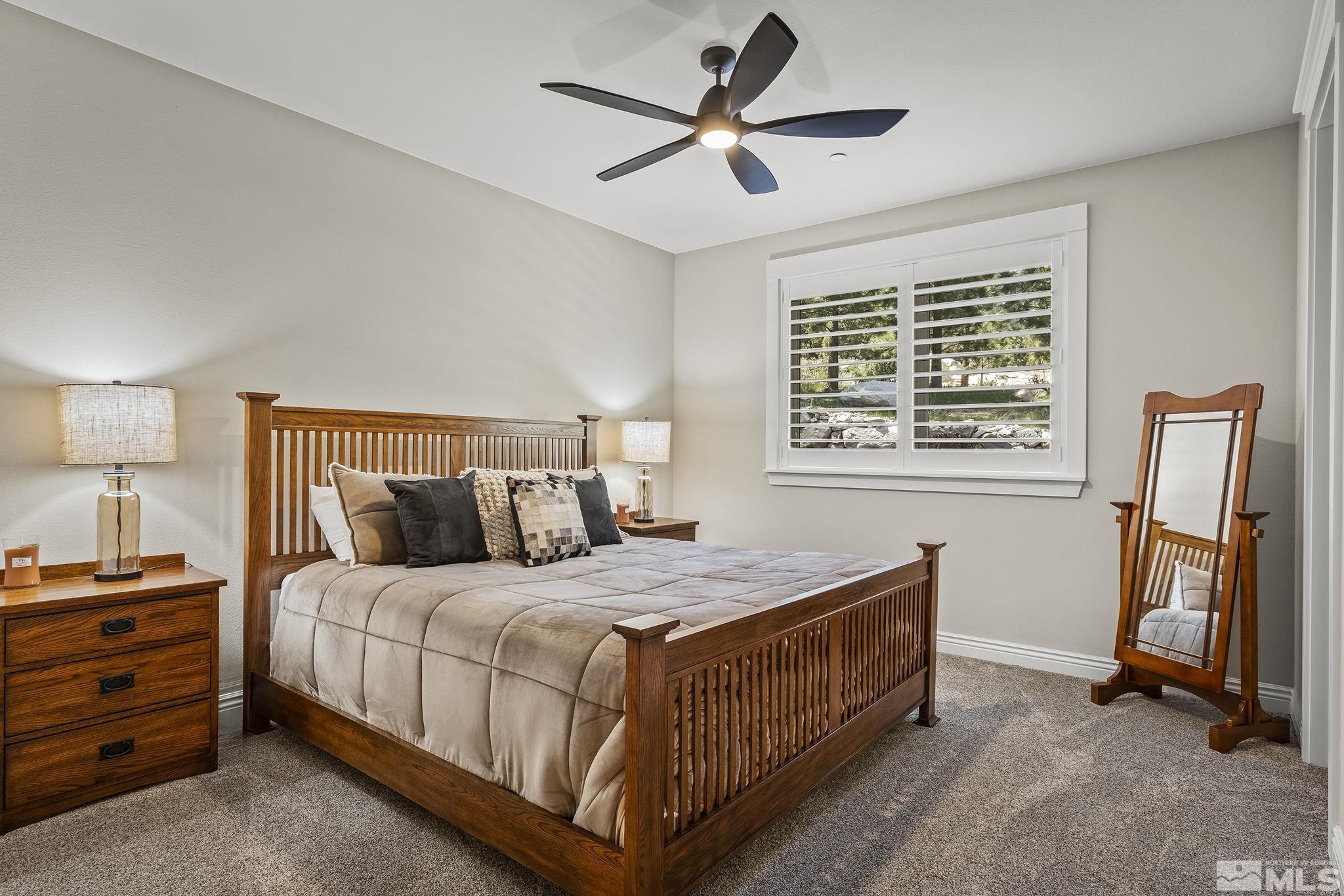 119 Five Creek Road Gardnerville, NV 89460 - Photo 31 of 40 a bedroom with a bed and a chandelier
