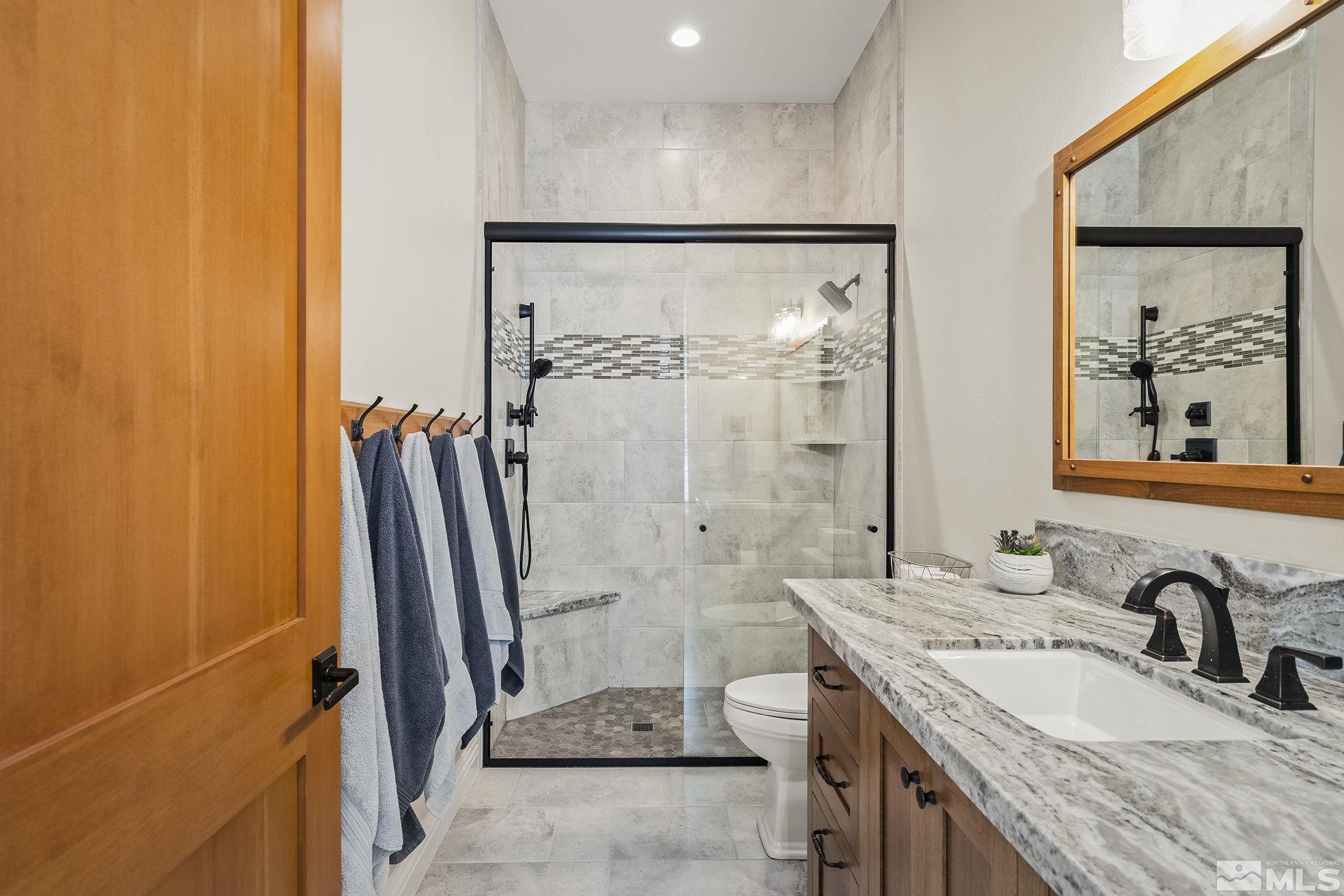 119 Five Creek Road Gardnerville, NV 89460 - Photo 34 of 40 a bathroom with a granite countertop sink a mirror and a shower