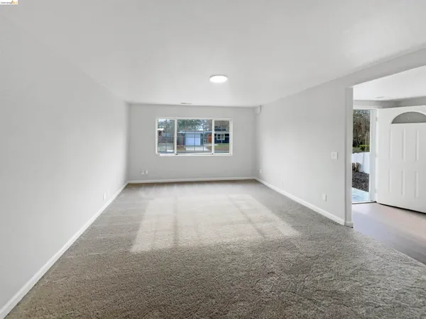 an empty room with a empty space and windows