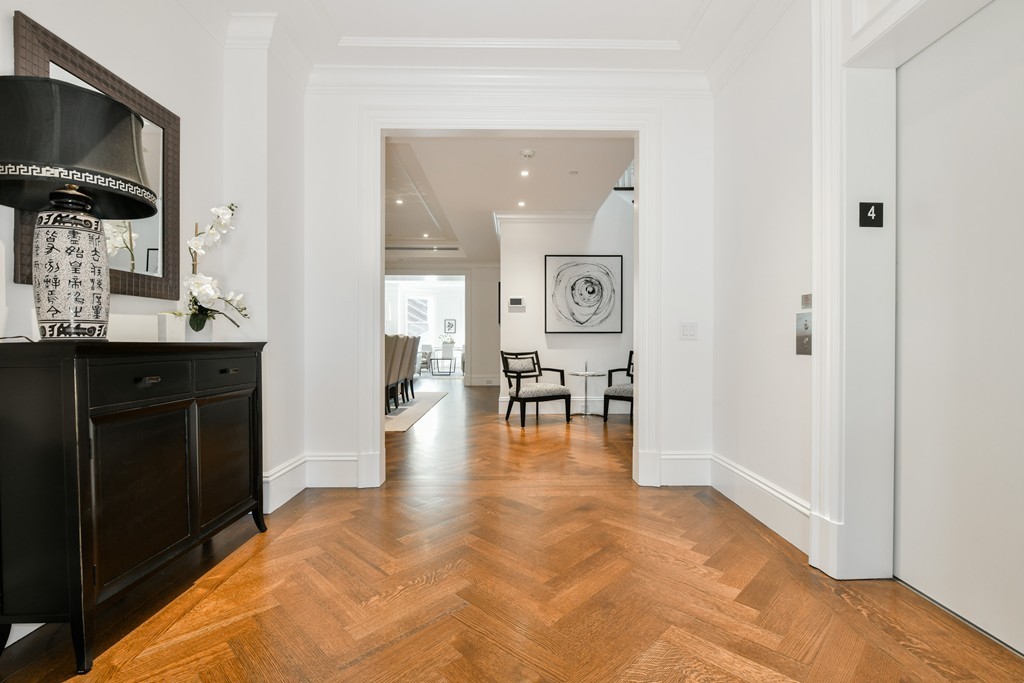 35 Commonwealth Avenue, Unit PH Boston, MA 02116 - Photo 11 of 25 a hallway with dining table and chairs