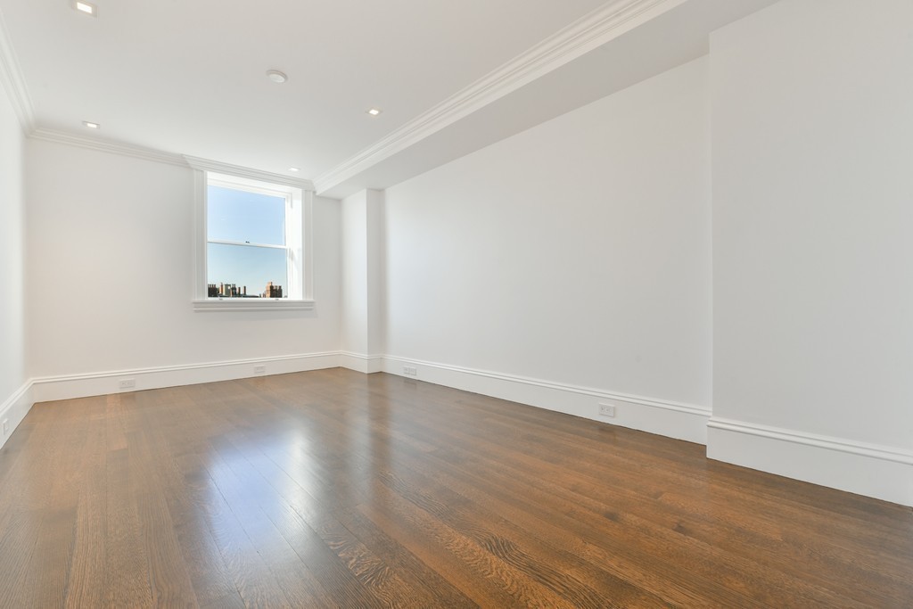 35 Commonwealth Avenue, Unit PH Boston, MA 02116 - Photo 17 of 25 a view of an empty room with wooden floor and a window