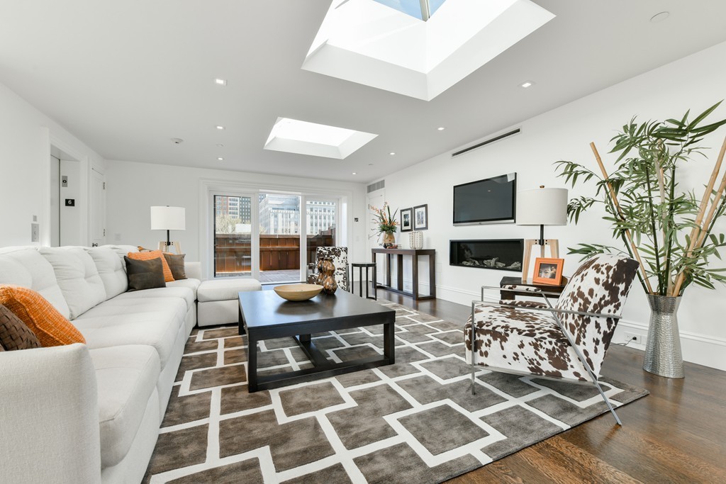 35 Commonwealth Avenue, Unit PH Boston, MA 02116 - Photo 21 of 25 a living room with furniture a rug and a fireplace