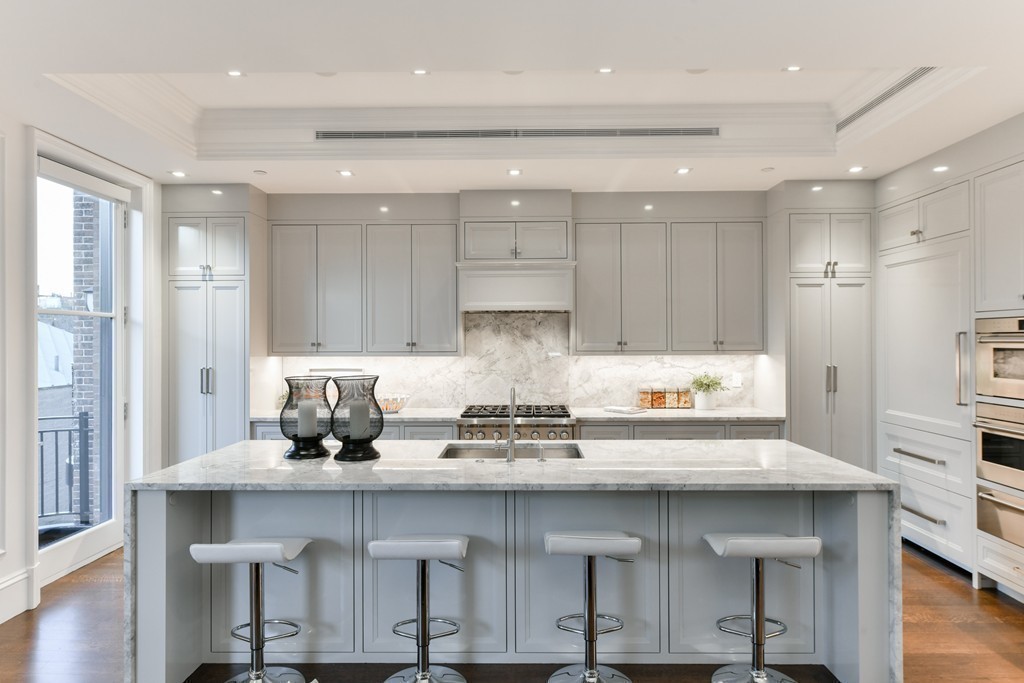 35 Commonwealth Avenue, Unit PH Boston, MA 02116 - Photo 8 of 25 a kitchen with kitchen island granite countertop a table and chairs in it