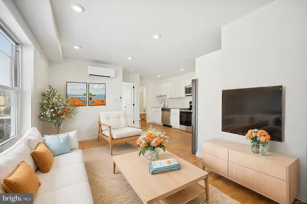 a living room with furniture and a flat screen tv
