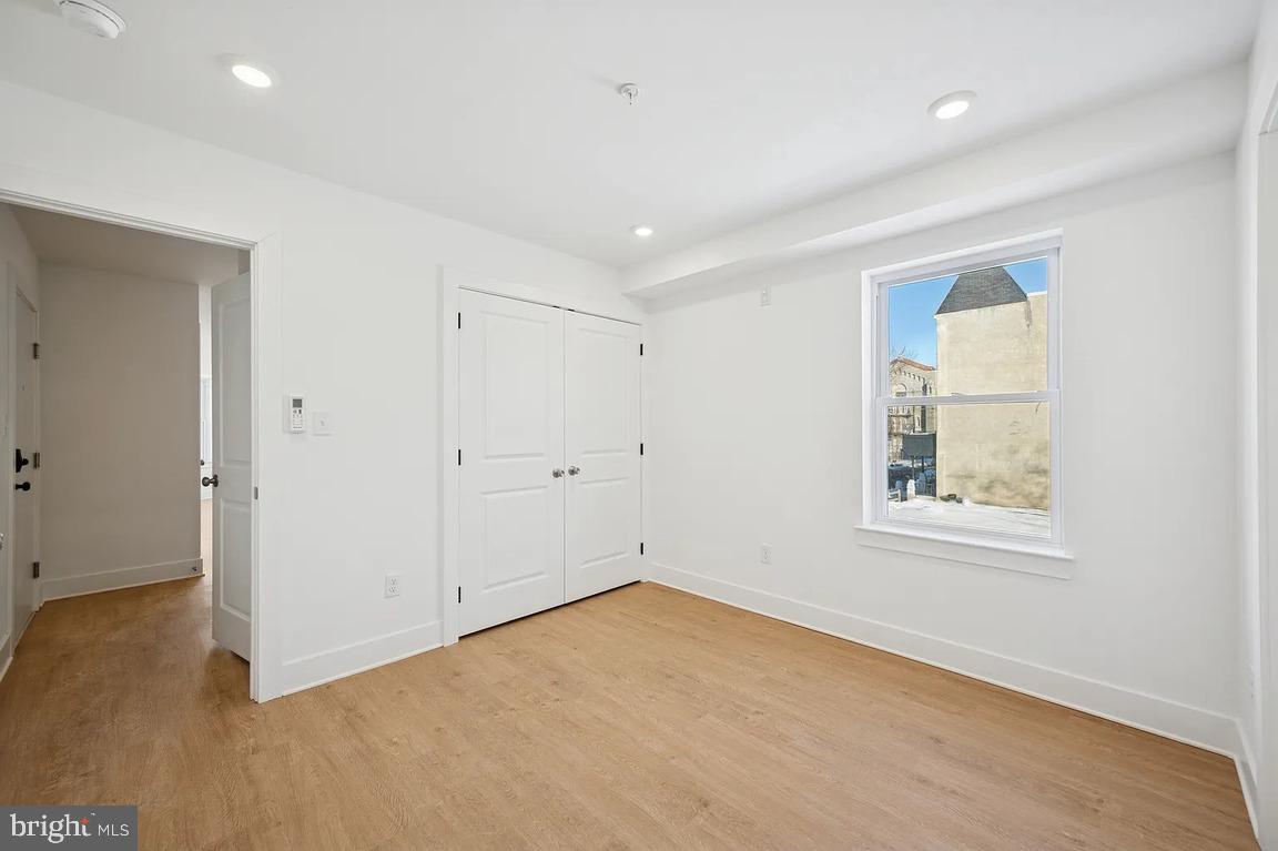 3413 North 19th Street, Unit 2F Philadelphia, PA 19140 - Photo 20 of 24 an empty room with a window and wooden floor