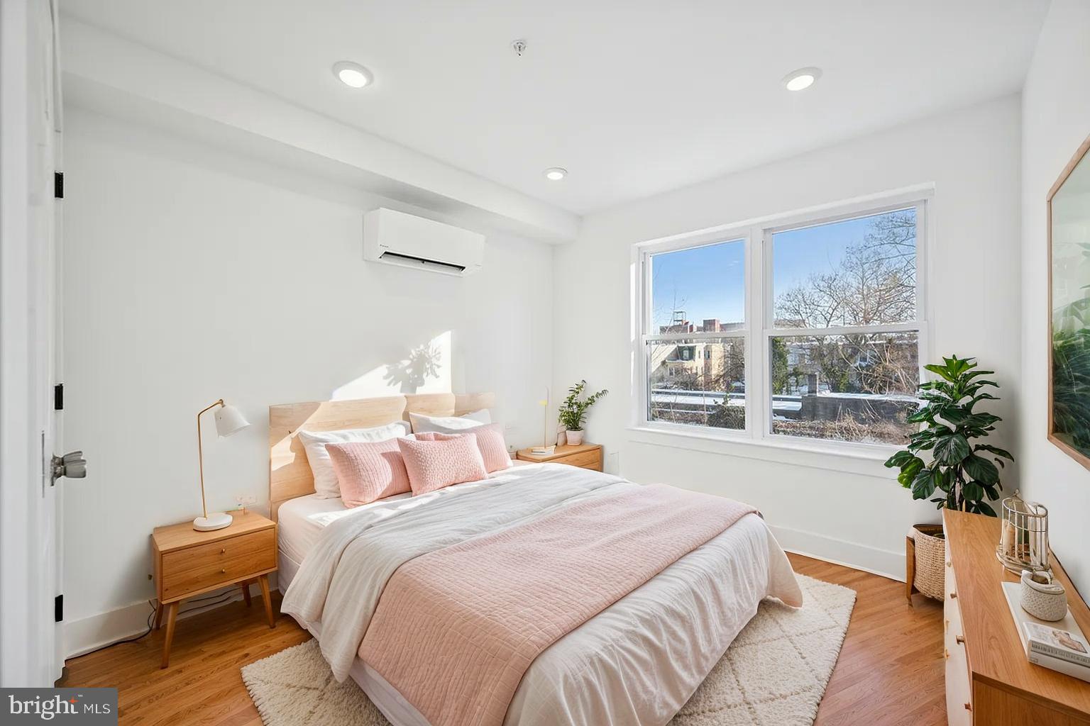 3413 North 19th Street, Unit 2F Philadelphia, PA 19140 - Photo 4 of 24 a bedroom with a large bed and a potted plant