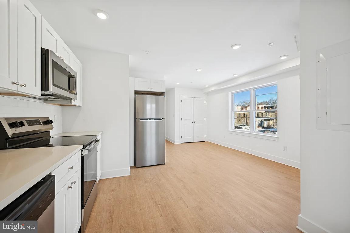 3413 North 19th Street, Unit 2F Philadelphia, PA 19140 - Photo 6 of 24 a view of a kitchen with electric appliances