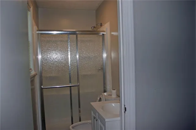 a bathroom with a glass shower door