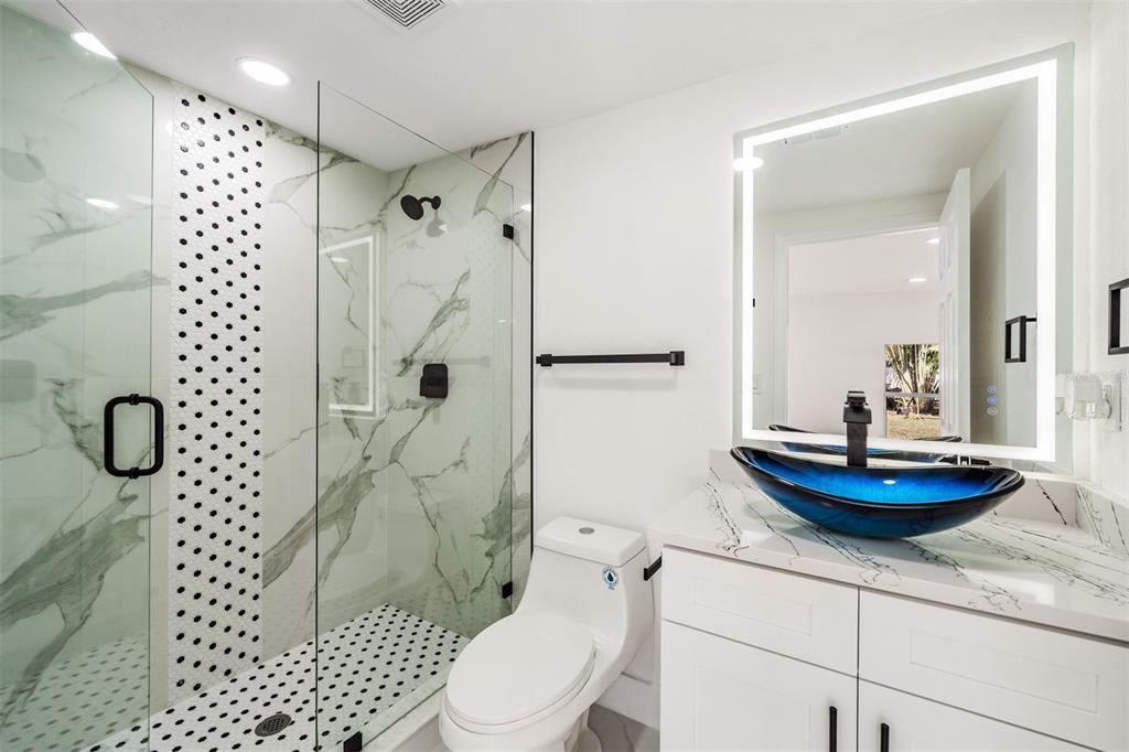 1413 May Street Lutz, FL 33548 - Photo 17 of 21 a bathroom with a sink toilet and shower