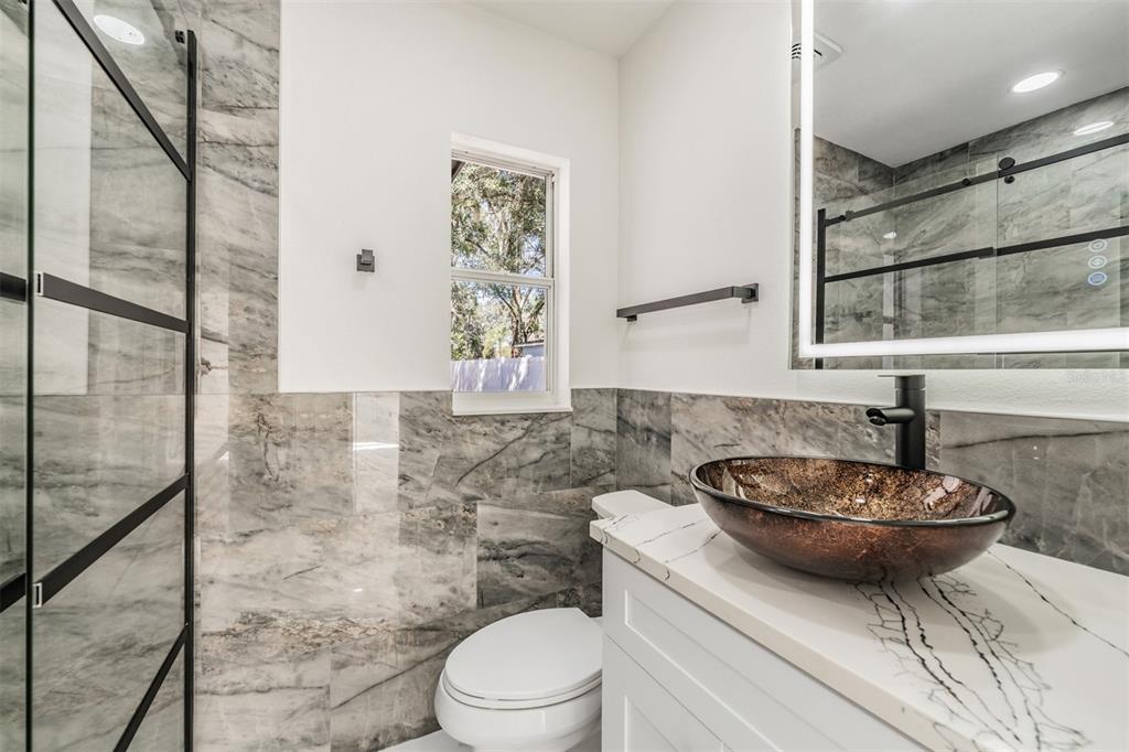 1413 May Street Lutz, FL 33548 - Photo 21 of 21 a bathroom with a toilet a sink and a mirror