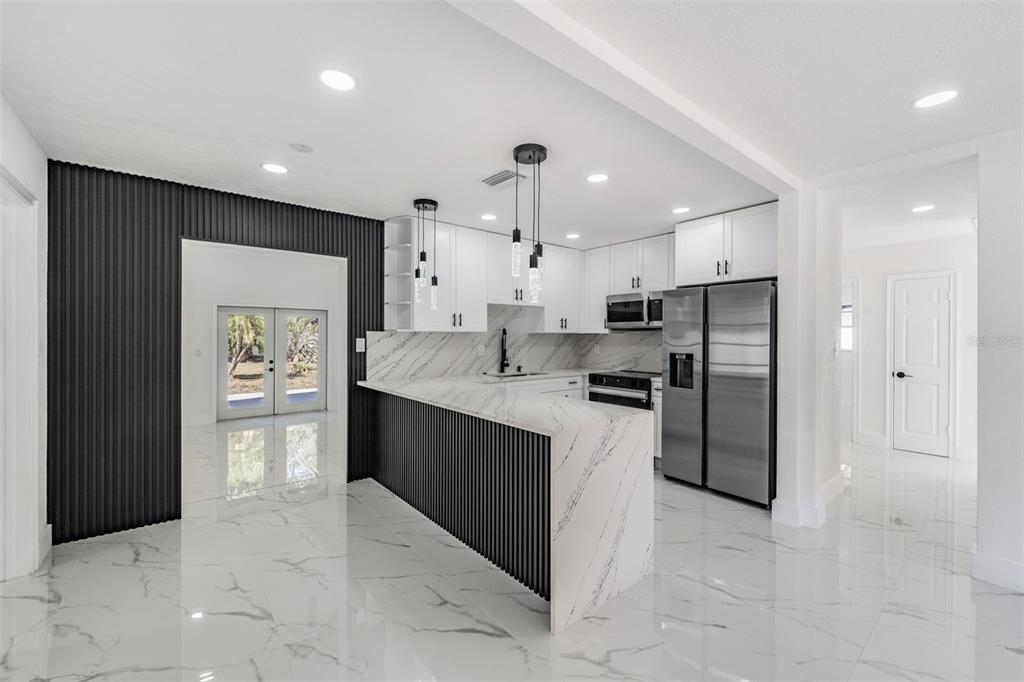 1413 May Street Lutz, FL 33548 - Photo 5 of 21 a large kitchen with cabinets and stainless steel appliances