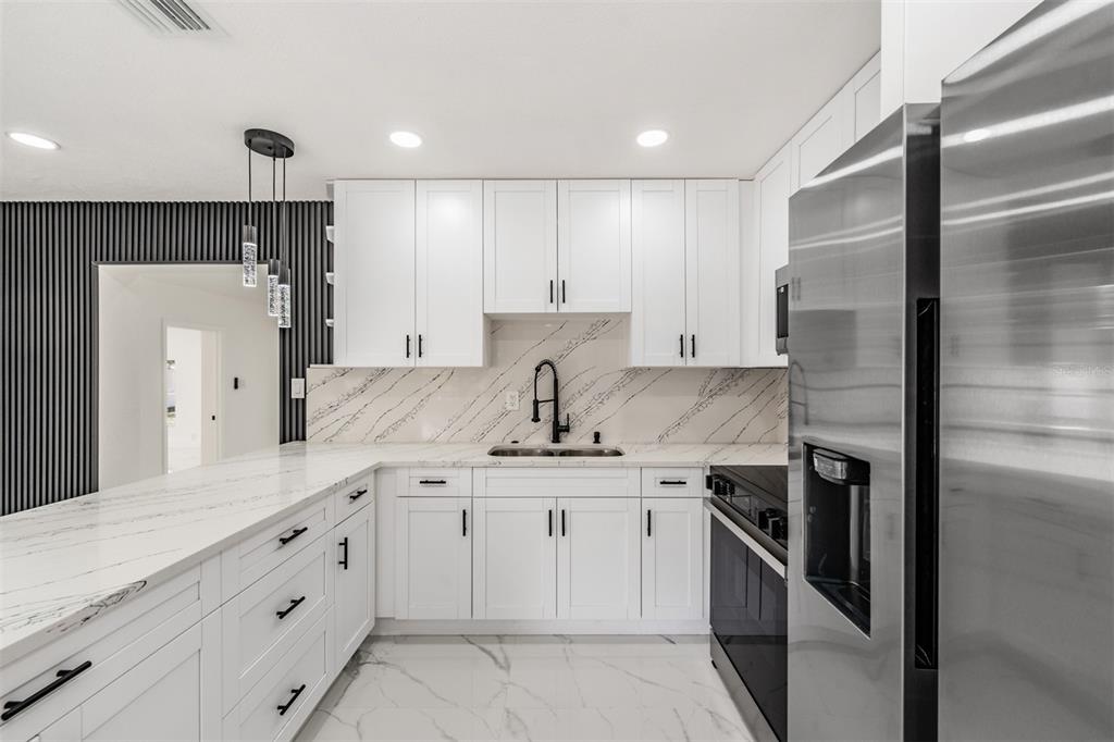 1413 May Street Lutz, FL 33548 - Photo 8 of 21 a kitchen with a sink stainless steel appliances and cabinets