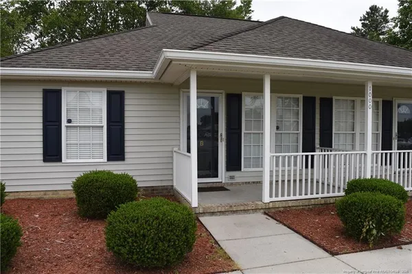 a view of a house with a small yard and a large window