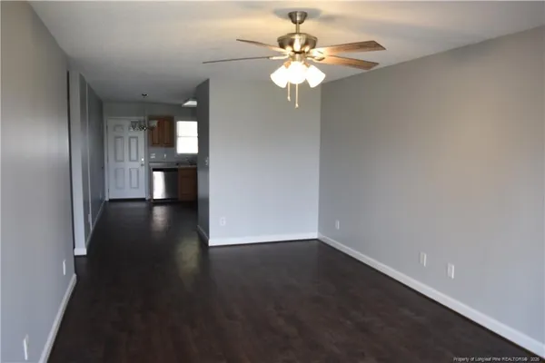 a view of an empty room with wooden floor