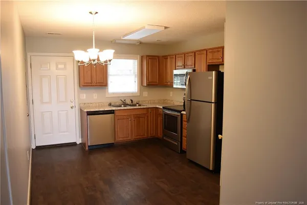 a kitchen with stainless steel appliances a refrigerator sink and cabinets
