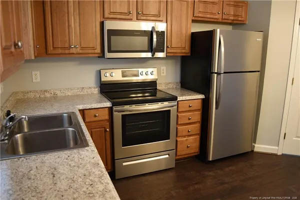 a kitchen with a stove microwave and refrigerator