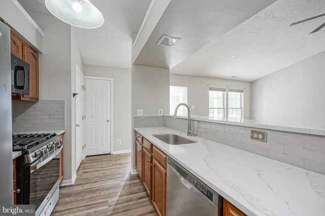 a kitchen that has a sink and a stove
