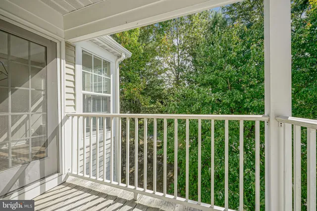 a view of a balcony with wooden floor
