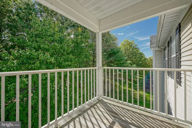 a view of a balcony with wooden floor