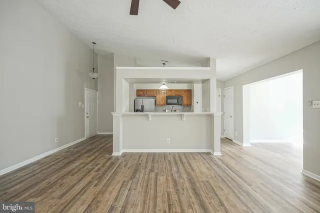 a view of a room with wooden floor and window