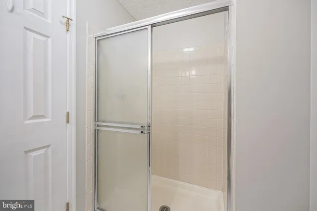 a bathroom with a glass shower door
